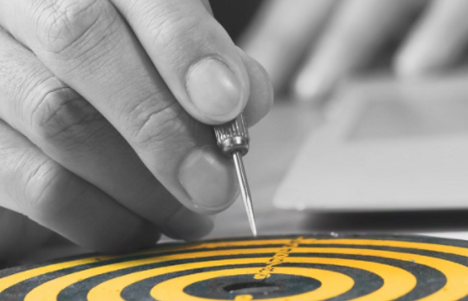 Hand with dart over a target